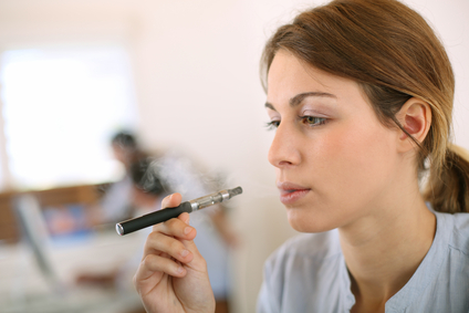 Portrait of woman smoking with electronic cigarette